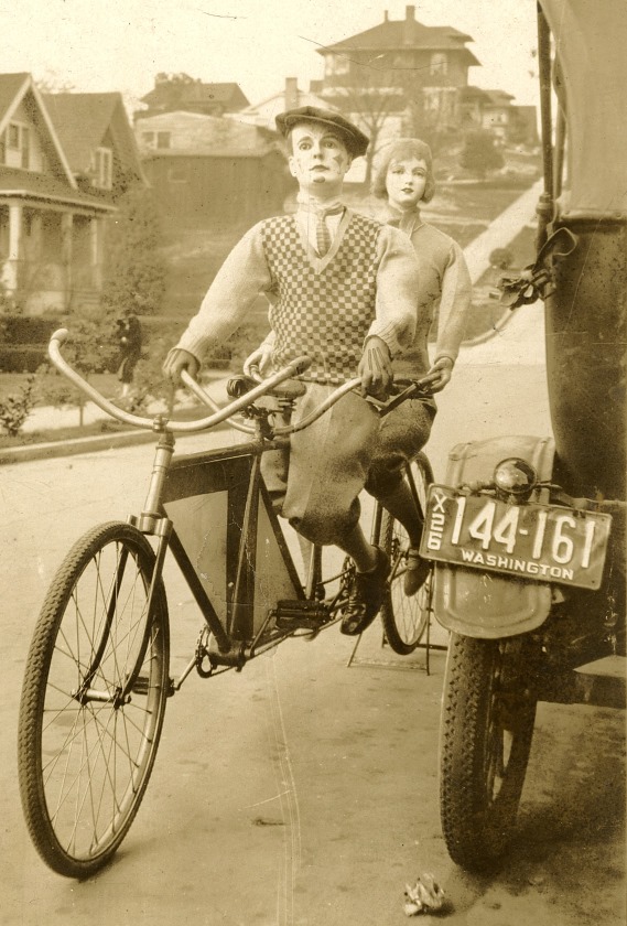 Mannequins posed on a tandem bicycle on the streets of Seattle, 1926