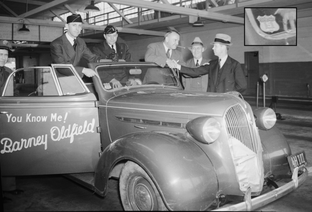 Barney Oldfield brings his Plymouth-sponsored tour to the Seattle municipal testing garage in May 1937