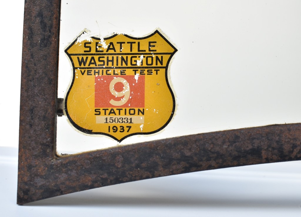 1937 Seattle vehicle test inspection sticker mounted on a 1930s windshield