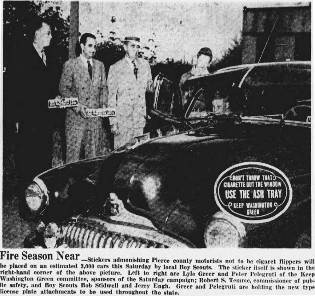 Newspaper photo from 1948 showing Keep Washington Green license plate toppers on display