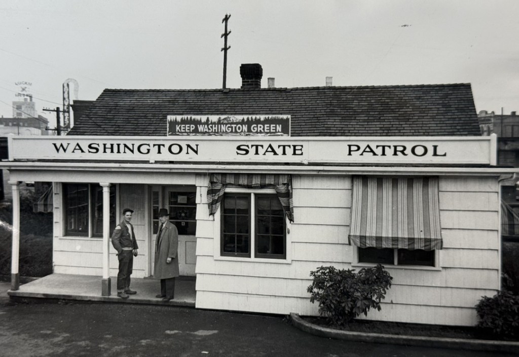 Washington State Patrol office in late 1940s with a Keep Washington Green sign on the roof
